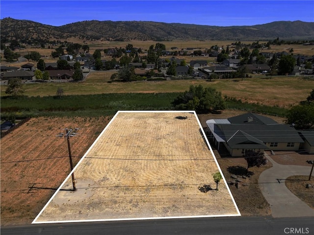28201 Stallion Springs Dr, Tehachapi, CA 93561 - aerial view of residential area with property parcel outlined and a mountain backdrop