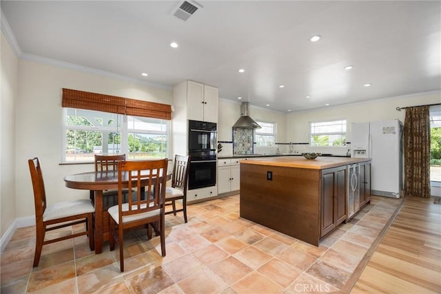 28201 Stallion Springs Dr, Tehachapi, CA 93561 - kitchen with white fridge with ice dispenser, wooden counters, ornamental molding, white cabinetry, and a kitchen island
