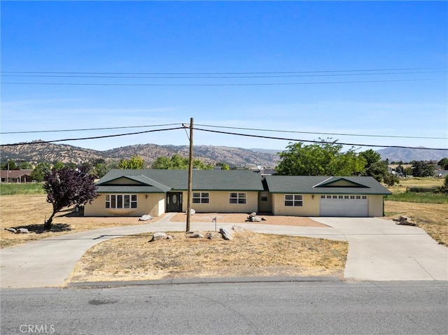 28201 Stallion Springs Dr, Tehachapi, CA 93561 - single story home featuring a mountain view, concrete driveway, and an attached garage