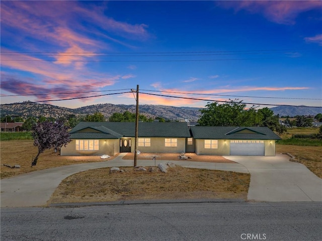 28201 Stallion Springs Dr, Tehachapi, CA 93561 - single story home with curved driveway, a mountain view, an attached garage, and stucco siding