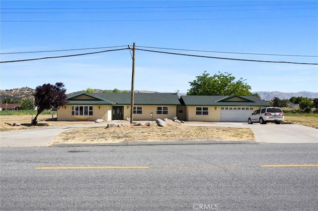 28201 Stallion Springs Dr, Tehachapi, CA 93561 - ranch-style house featuring concrete driveway, an attached garage, and a mountain view