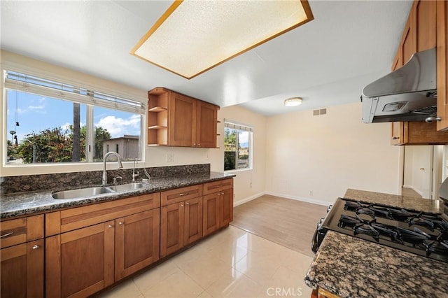 1524 Acacia Unit 5, Alhambra, CA 91801 - kitchen with range hood, gas stove, brown cabinetry, open shelves, and light tile patterned floors