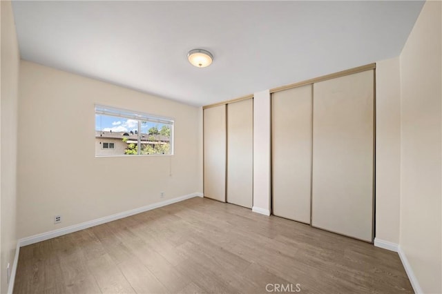 1524 Acacia Unit 5, Alhambra, CA 91801 - unfurnished bedroom with two closets and light wood-style floors