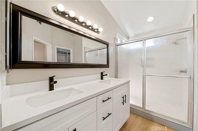 15965 Peach Tree Ln, Fontana, CA 92337 - bathroom with double vanity, a shower stall, wood finished floors, and recessed lighting