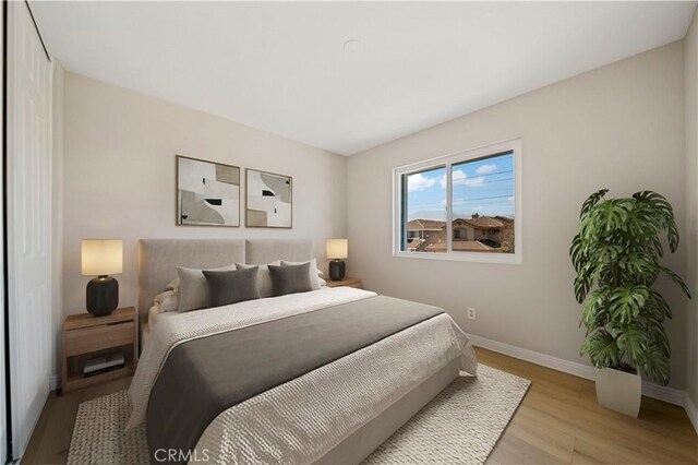 15965 Peach Tree Ln, Fontana, CA 92337 - bedroom featuring light wood-style floors and a closet