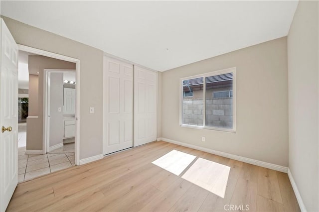 15965 Peach Tree Ln, Fontana, CA 92337 - unfurnished bedroom with light wood-style flooring and a closet