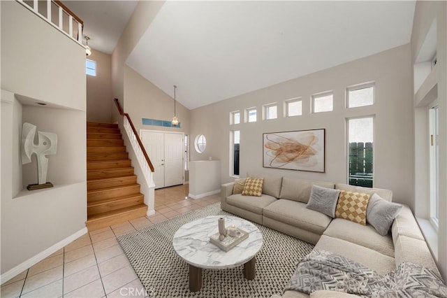 15965 Peach Tree Ln, Fontana, CA 92337 - living room with high vaulted ceiling, light tile patterned floors, healthy amount of natural light, and stairs