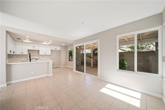 15965 Peach Tree Ln, Fontana, CA 92337 - unfurnished living room with light tile patterned floors and recessed lighting