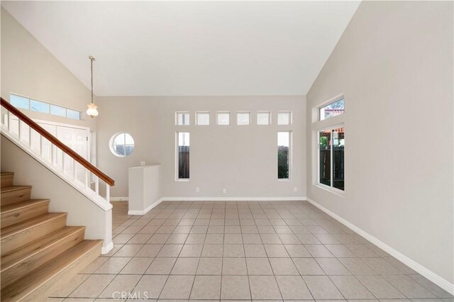 15965 Peach Tree Ln, Fontana, CA 92337 - foyer entrance with high vaulted ceiling, stairs, and light tile patterned flooring