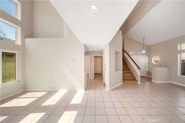 15965 Peach Tree Ln, Fontana, CA 92337 - foyer with light tile patterned floors, stairs, healthy amount of natural light, high vaulted ceiling, and recessed lighting