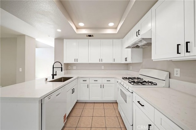 15965 Peach Tree Ln, Fontana, CA 92337 - kitchen with white appliances, under cabinet range hood, a peninsula, a tray ceiling, and recessed lighting