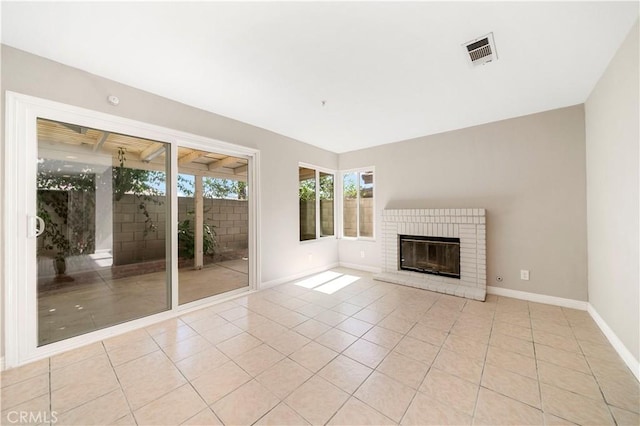 15965 Peach Tree Ln, Fontana, CA 92337 - unfurnished living room with light tile patterned floors and a brick fireplace
