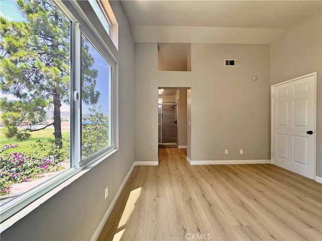 15965 Peach Tree Ln, Fontana, CA 92337 - unfurnished bedroom with light wood-style flooring and a high ceiling