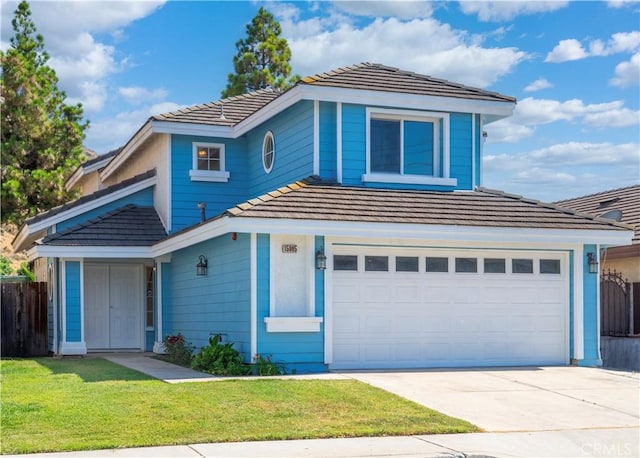 15965 Peach Tree Ln, Fontana, CA 92337 - view of front of house with concrete driveway, a tile roof, and an attached garage