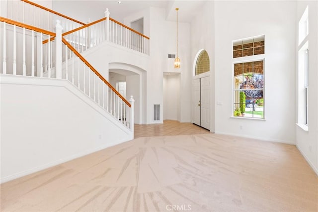 2311 Gillingham Cir, Thousand Oaks, CA 91362 - carpeted entrance foyer with a high ceiling, stairway, and arched walkways