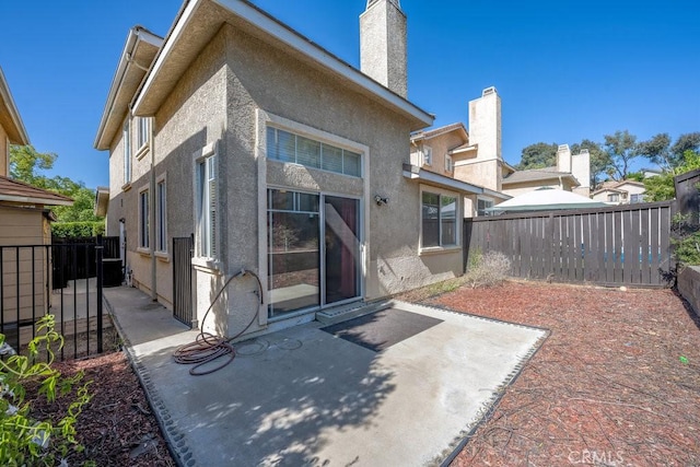 27625 Primrose Ln, Castaic, CA 91384 - back of property with a patio, stucco siding, a chimney, and a fenced backyard