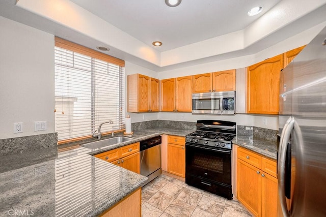 27625 Primrose Ln, Castaic, CA 91384 - kitchen with stainless steel appliances, dark stone counters, a tray ceiling, and recessed lighting