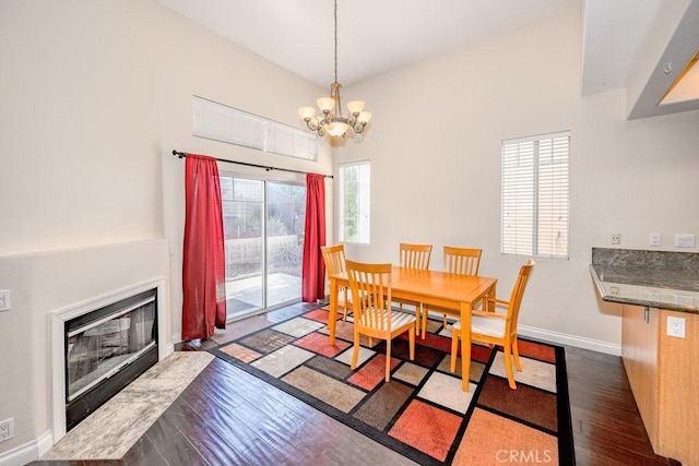 27625 Primrose Ln, Castaic, CA 91384 - dining area with dark wood-style floors, a chandelier, and a fireplace with flush hearth