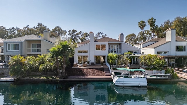 22627 Lakeside Ln, Lake Forest, CA 92630 - back of property featuring a balcony, stucco siding, and a water view