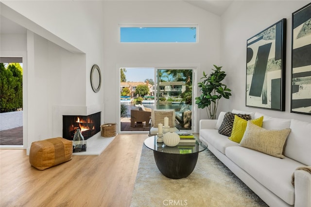 22627 Lakeside Ln, Lake Forest, CA 92630 - living area featuring wood finished floors, a lit fireplace, and high vaulted ceiling