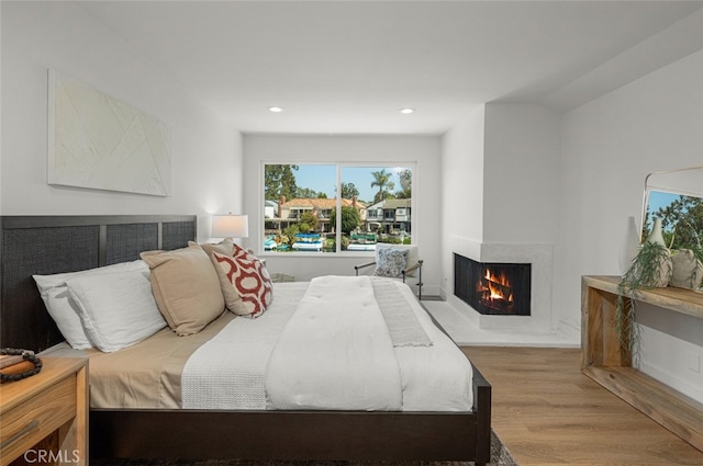 22627 Lakeside Ln, Lake Forest, CA 92630 - bedroom with wood finished floors, a multi sided fireplace, and recessed lighting