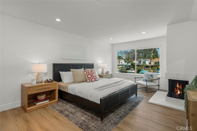 22627 Lakeside Ln, Lake Forest, CA 92630 - bedroom featuring wood finished floors, a multi sided fireplace, and recessed lighting