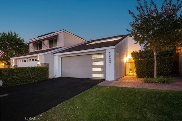 22627 Lakeside Ln, Lake Forest, CA 92630 - view of front facade with stucco siding, driveway, and an attached garage