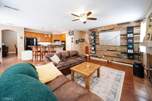 42365 Westar Ct, Murrieta, CA 92562 - living room featuring a ceiling fan, wood walls, arched walkways, recessed lighting, and light wood finished floors