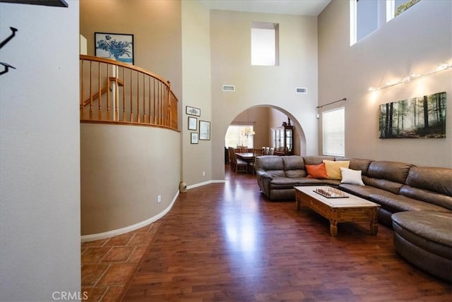 42365 Westar Ct, Murrieta, CA 92562 - living room with arched walkways, a towering ceiling, and wood finished floors