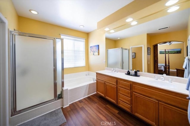 42365 Westar Ct, Murrieta, CA 92562 - bathroom featuring a stall shower, a bath, double vanity, wood finished floors, and recessed lighting