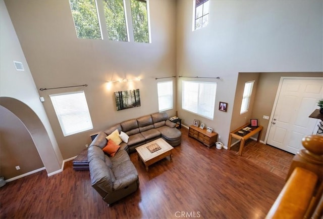42365 Westar Ct, Murrieta, CA 92562 - living area with a towering ceiling, plenty of natural light, wood finished floors, and arched walkways