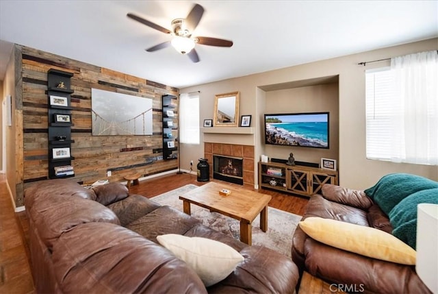 42365 Westar Ct, Murrieta, CA 92562 - living area featuring a ceiling fan, plenty of natural light, a fireplace, wood finished floors, and wooden walls