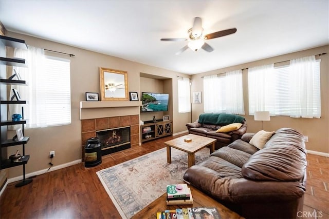 42365 Westar Ct, Murrieta, CA 92562 - living room with ceiling fan, healthy amount of natural light, a tiled fireplace, and wood finished floors