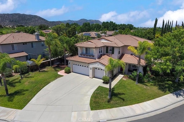 42365 Westar Ct, Murrieta, CA 92562 - mediterranean / spanish-style home featuring stucco siding, concrete driveway, a tile roof, a mountain view, and an attached garage