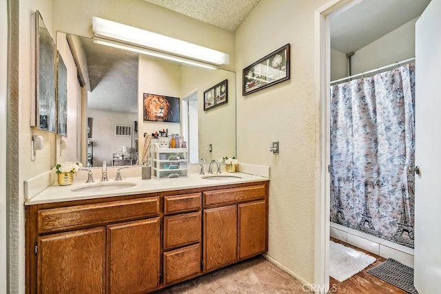 2134 Moonlight Ct, Palmdale, CA 93550 - bathroom with double vanity, a textured ceiling, and curtained shower