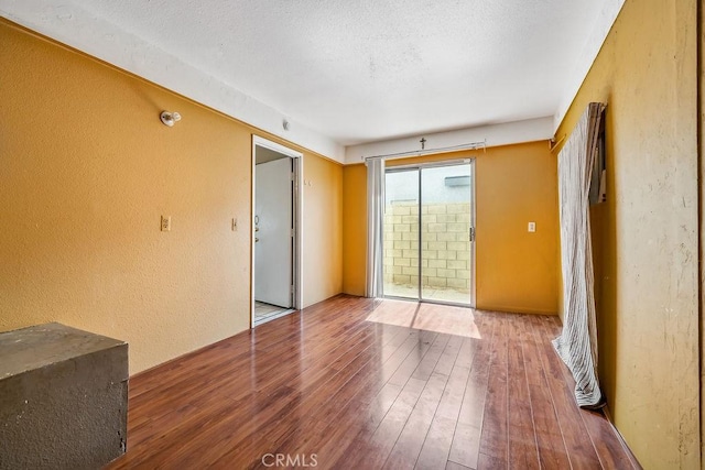 2134 Moonlight Ct, Palmdale, CA 93550 - unfurnished room with a textured wall and hardwood / wood-style floors