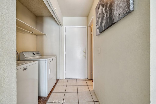 2134 Moonlight Ct, Palmdale, CA 93550 - laundry area with washing machine and dryer and light tile patterned flooring