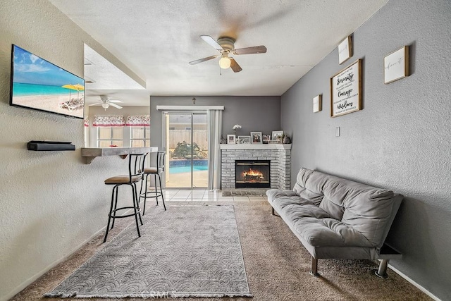 2134 Moonlight Ct, Palmdale, CA 93550 - living area featuring ceiling fan, a textured wall, carpet flooring, a brick fireplace, and a textured ceiling