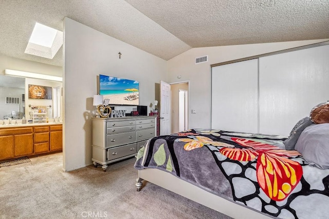 2134 Moonlight Ct, Palmdale, CA 93550 - bedroom with a skylight, vaulted ceiling, a closet, a textured ceiling, and light carpet
