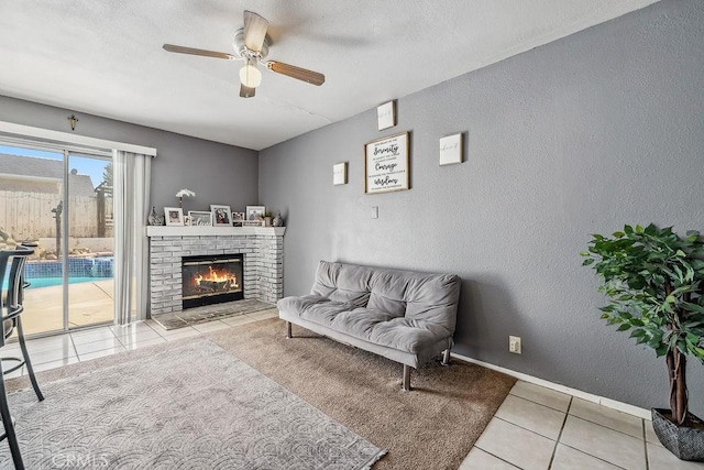 2134 Moonlight Ct, Palmdale, CA 93550 - living room featuring a ceiling fan, tile patterned flooring, a textured wall, and a brick fireplace