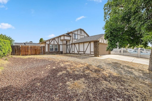 2134 Moonlight Ct, Palmdale, CA 93550 - rear view of property with concrete driveway and an attached garage