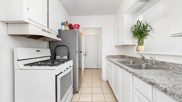 533 E Fredricks St, Barstow, CA 92311 - kitchen featuring white gas range oven, white cabinetry, light tile patterned floors, and light countertops