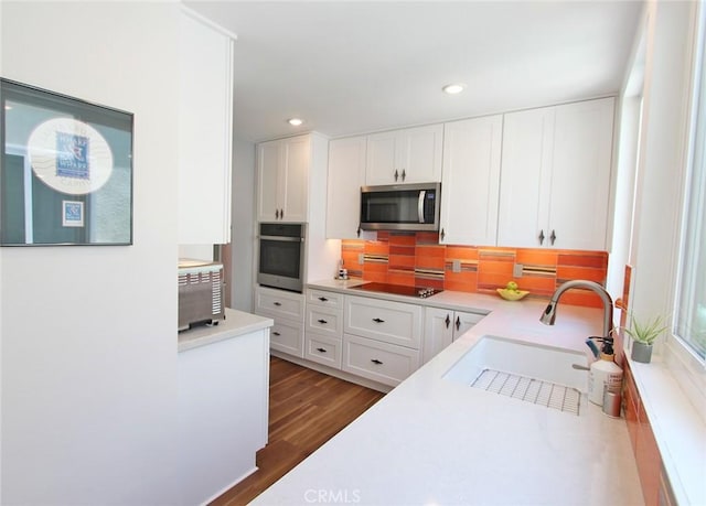 170 Avenida Majorca Unit A, Laguna Woods, CA 92637 - kitchen with appliances with stainless steel finishes, white cabinetry, light countertops, decorative backsplash, and recessed lighting