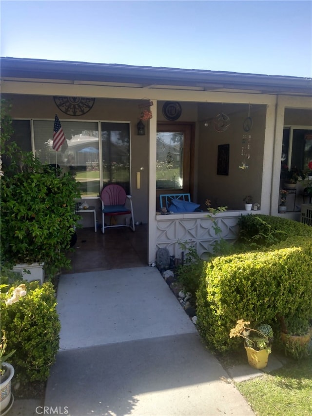 13141 Shawnee Ln Unit M-11 # 267-C, Seal Beach, CA 90740 - view of exterior entry with covered porch and stucco siding