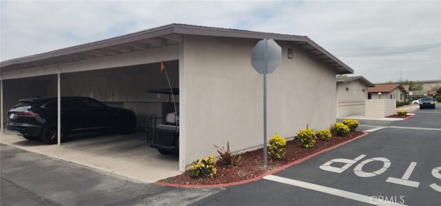13141 Shawnee Ln Unit M-11 # 267-C, Seal Beach, CA 90740 - view of side of home featuring covered parking