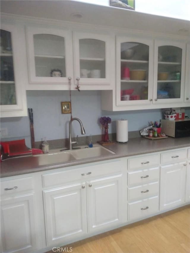 13141 Shawnee Ln Unit M-11 # 267-C, Seal Beach, CA 90740 - kitchen with glass insert cabinets, white cabinetry, and light wood-type flooring