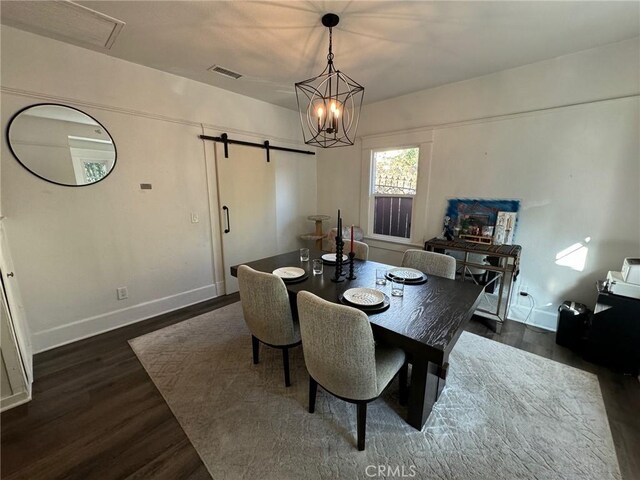 1355 N Gordon St, Pomona, CA 91768 - dining room featuring dark wood-style flooring, a barn door, and a chandelier