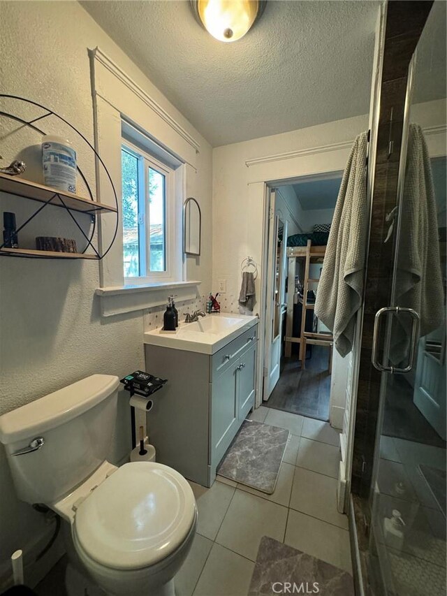 1355 N Gordon St, Pomona, CA 91768 - full bathroom featuring vanity, a shower stall, tile patterned floors, and a textured ceiling