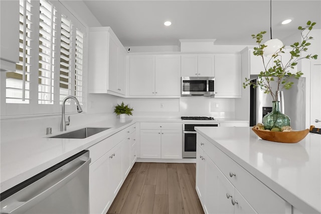 1768 Camellia Ln, Redlands, CA 92374 - kitchen with stainless steel appliances, light countertops, recessed lighting, white cabinets, and light wood-type flooring