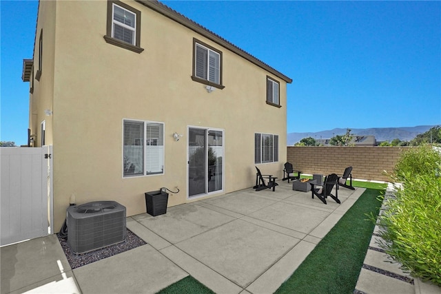 1768 Camellia Ln, Redlands, CA 92374 - back of house featuring stucco siding, a patio area, a mountain view, and a gate